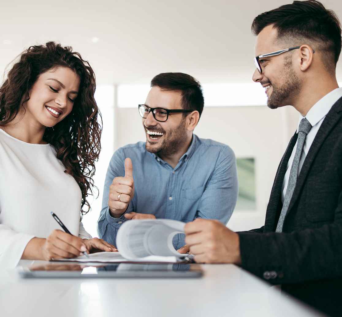 Three colleagues discussing in an office setting.